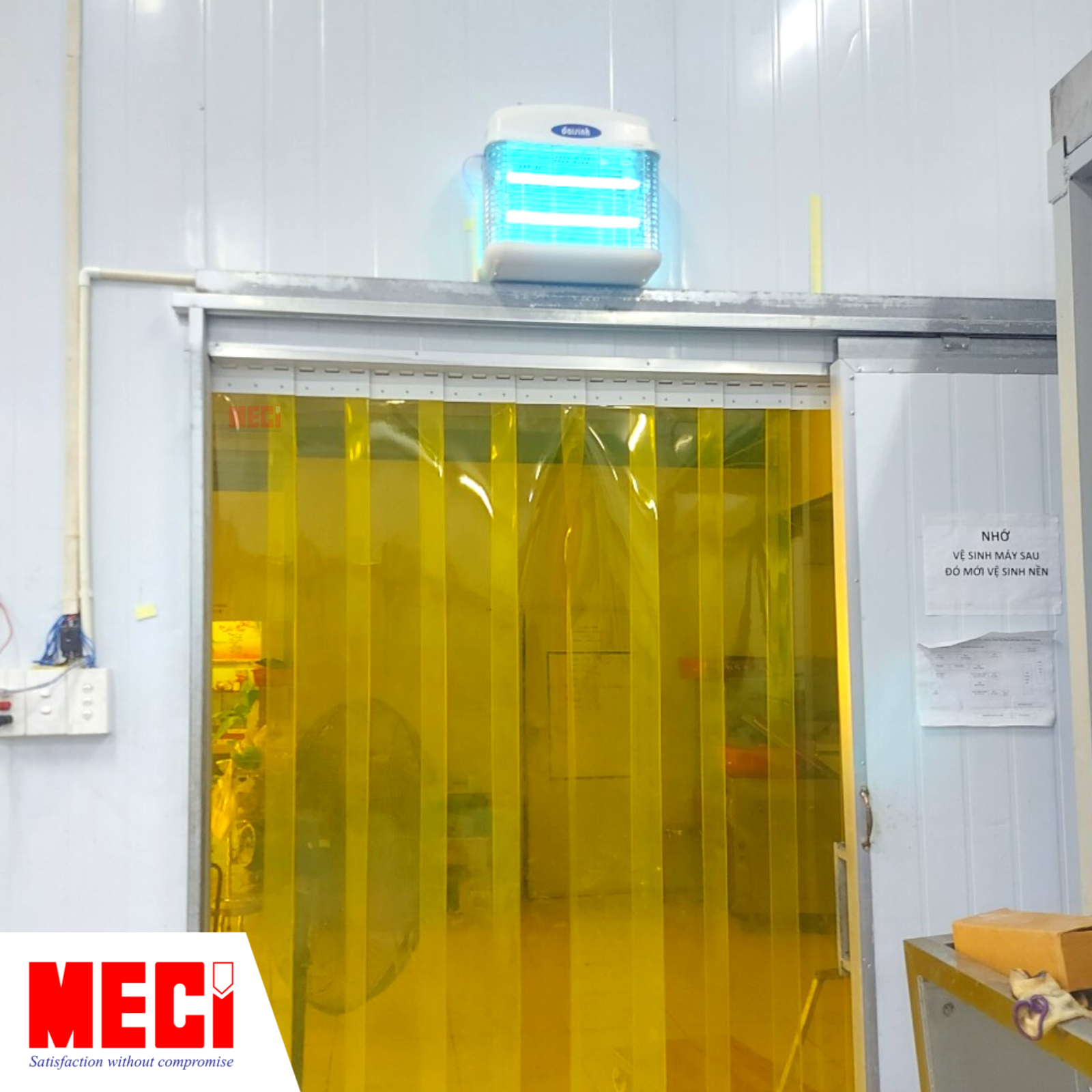 Đèn diệt côn trùng được lắp phía trên màn nhựa PVC màu vàng tại cửa của nhà máy chế biến tổ yến